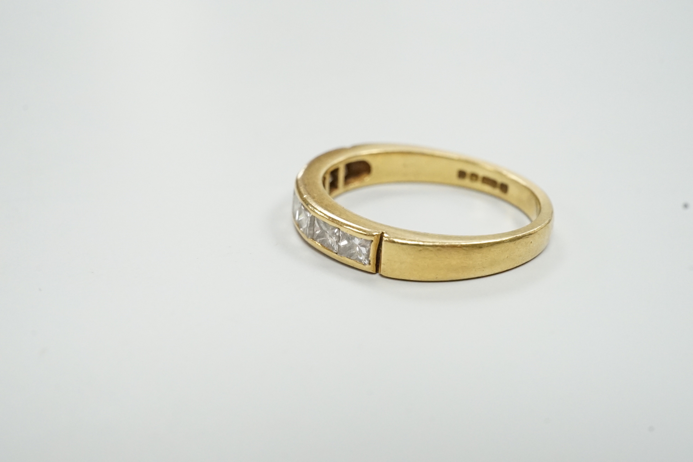 A modern 18ct gold and eight stone princess? cut diamond set half hoop ring, size M/N, gross weight 3.8 grams.